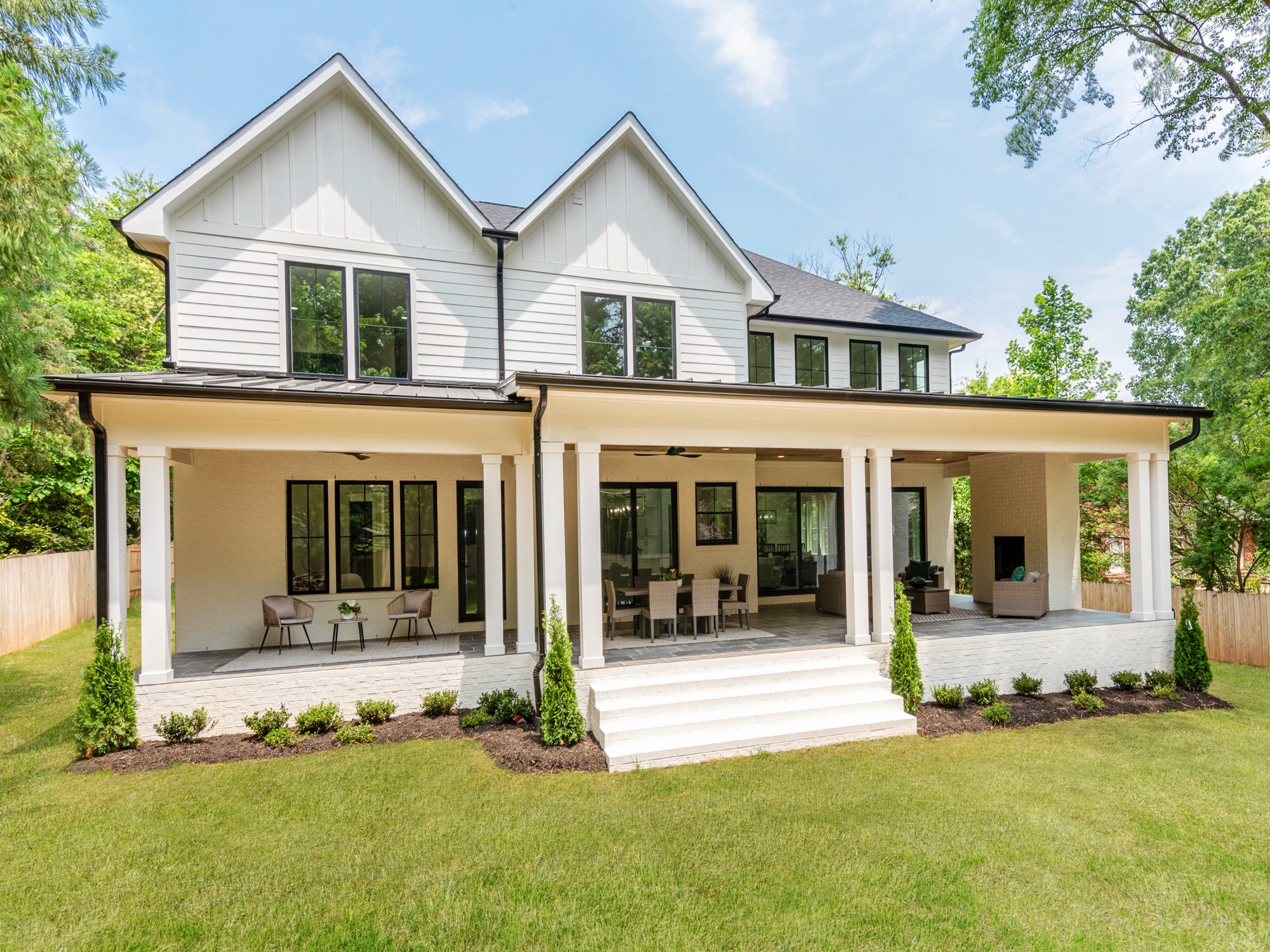 Front porch detail showing cedar columns and board-and-batten siding — Brantham modern farmhouse by Stillman Properties Charlotte NC