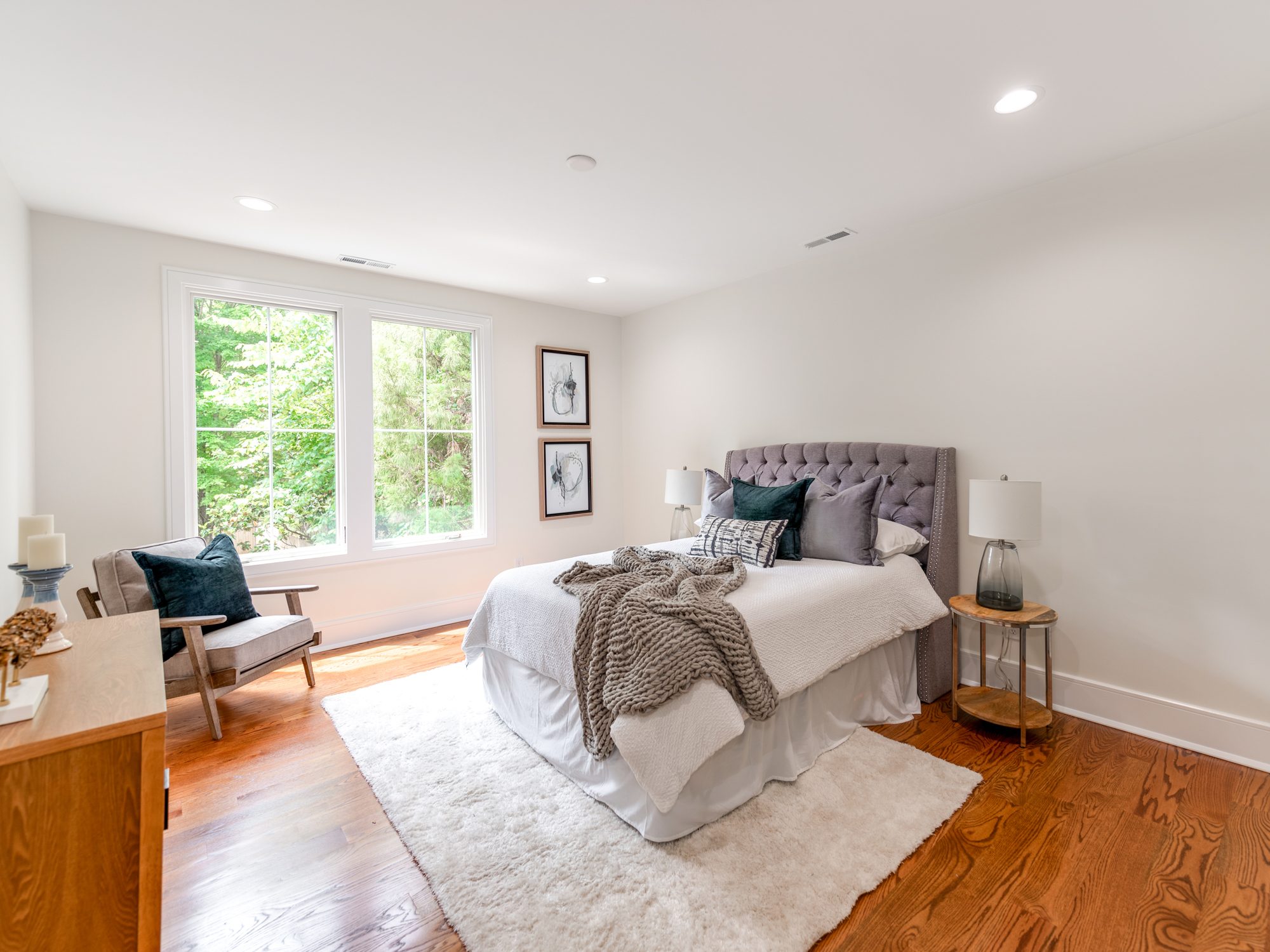 Guest bedroom with vaulted ceiling and layered textures — Brantham by Stillman Properties Charlotte NC