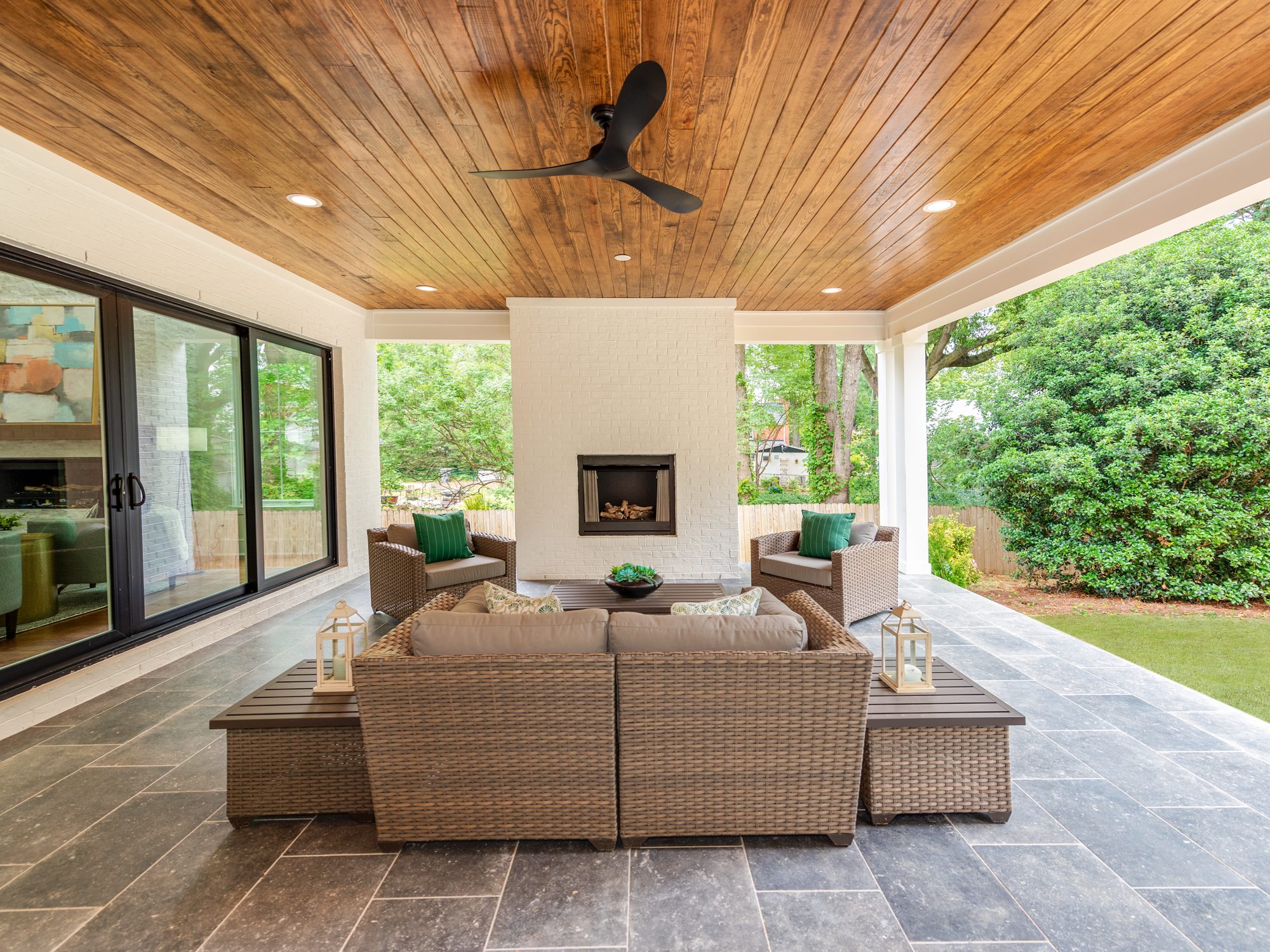 Outdoor stone fireplace beneath the cedar ceiling — Brantham by Stillman Properties Charlotte NC