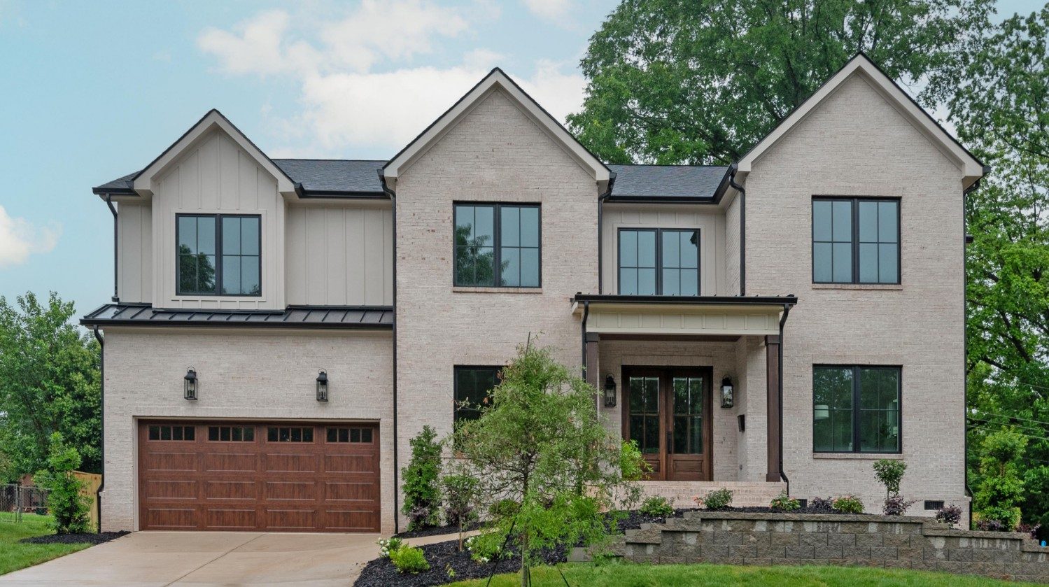 Bywood modern farmhouse front elevation with steep gables and black-trimmed windows — Stillman Properties Charlotte NC