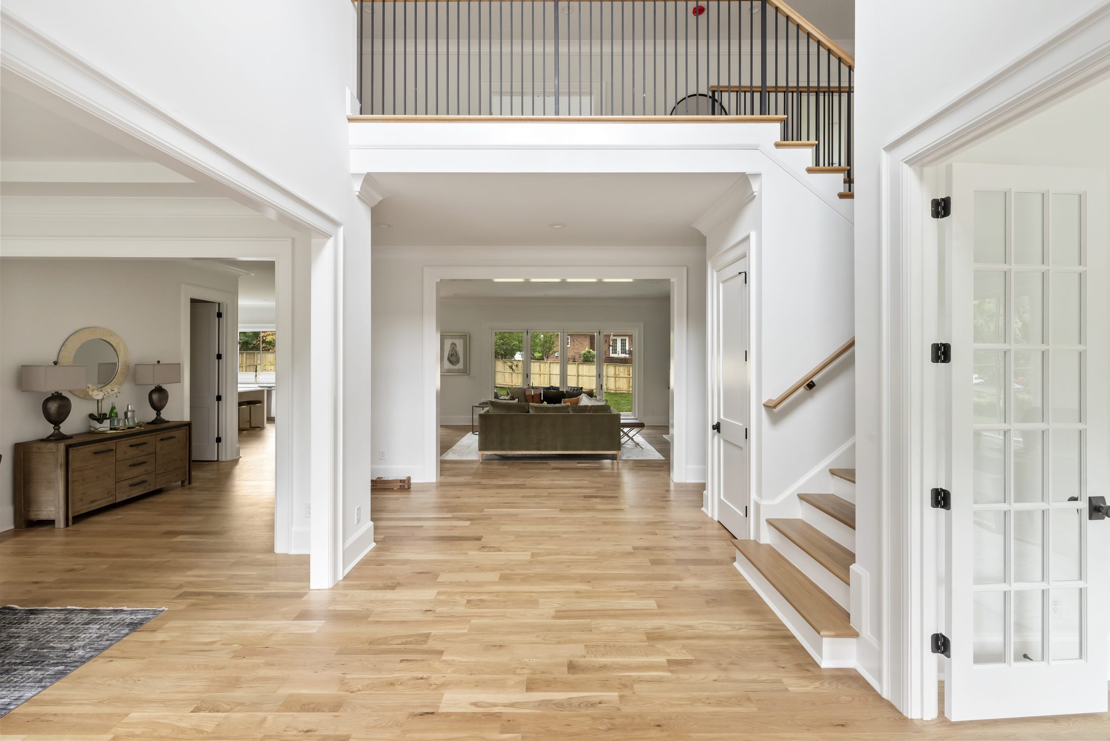 Vaulted two-story foyer with white oak floors and open staircase — Bywood by Stillman Properties Charlotte NC