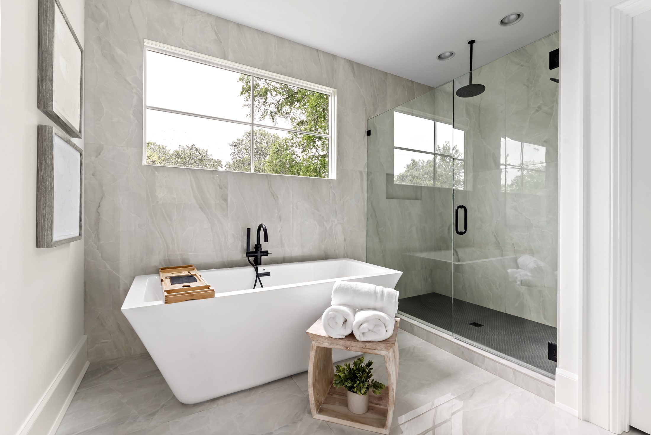 Primary bath with freestanding soaking tub and glass-enclosed walk-in shower — Bywood by Stillman Properties Charlotte NC