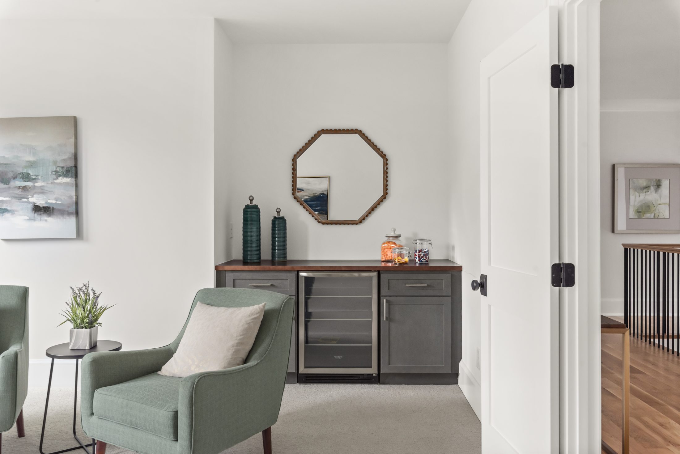 Loft wet bar with gray cabinetry, walnut counter, and beverage fridge — Bywood by Stillman Properties Charlotte NC