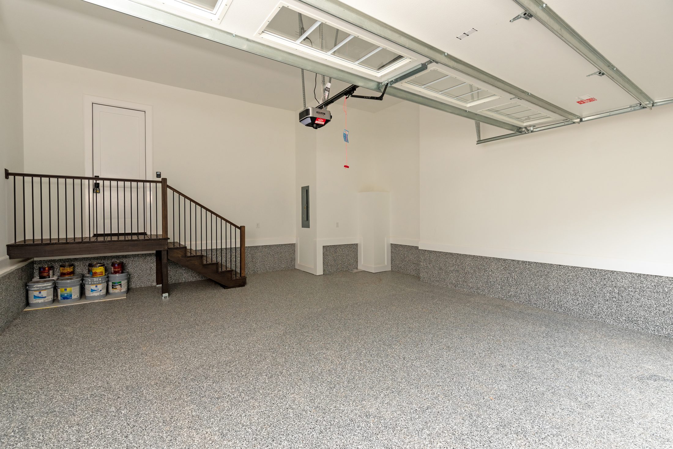 Finished garage with epoxy-flake floor and interior staircase — Bywood by Stillman Properties Charlotte NC
