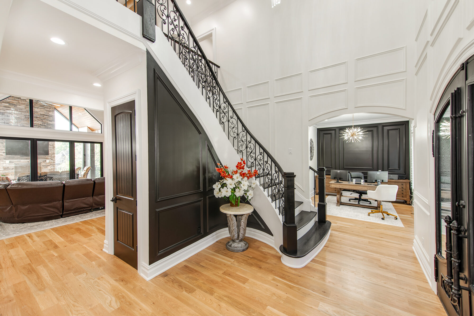 Foyer with custom paneled staircase wall and sightlines to the great room and office — Coddle Creek by Stillman Properties Concord NC