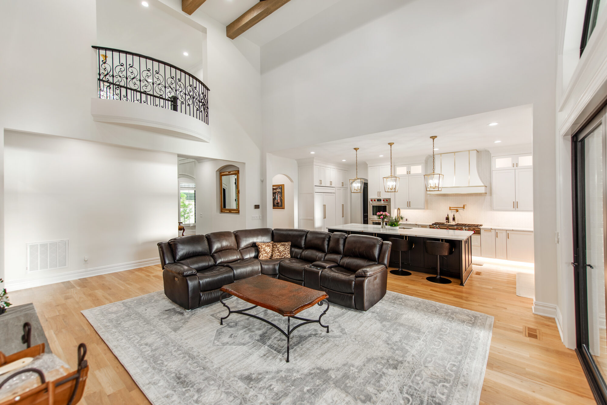 Great room looking toward the open chef's kitchen with juliet balcony above — Coddle Creek by Stillman Properties Concord NC