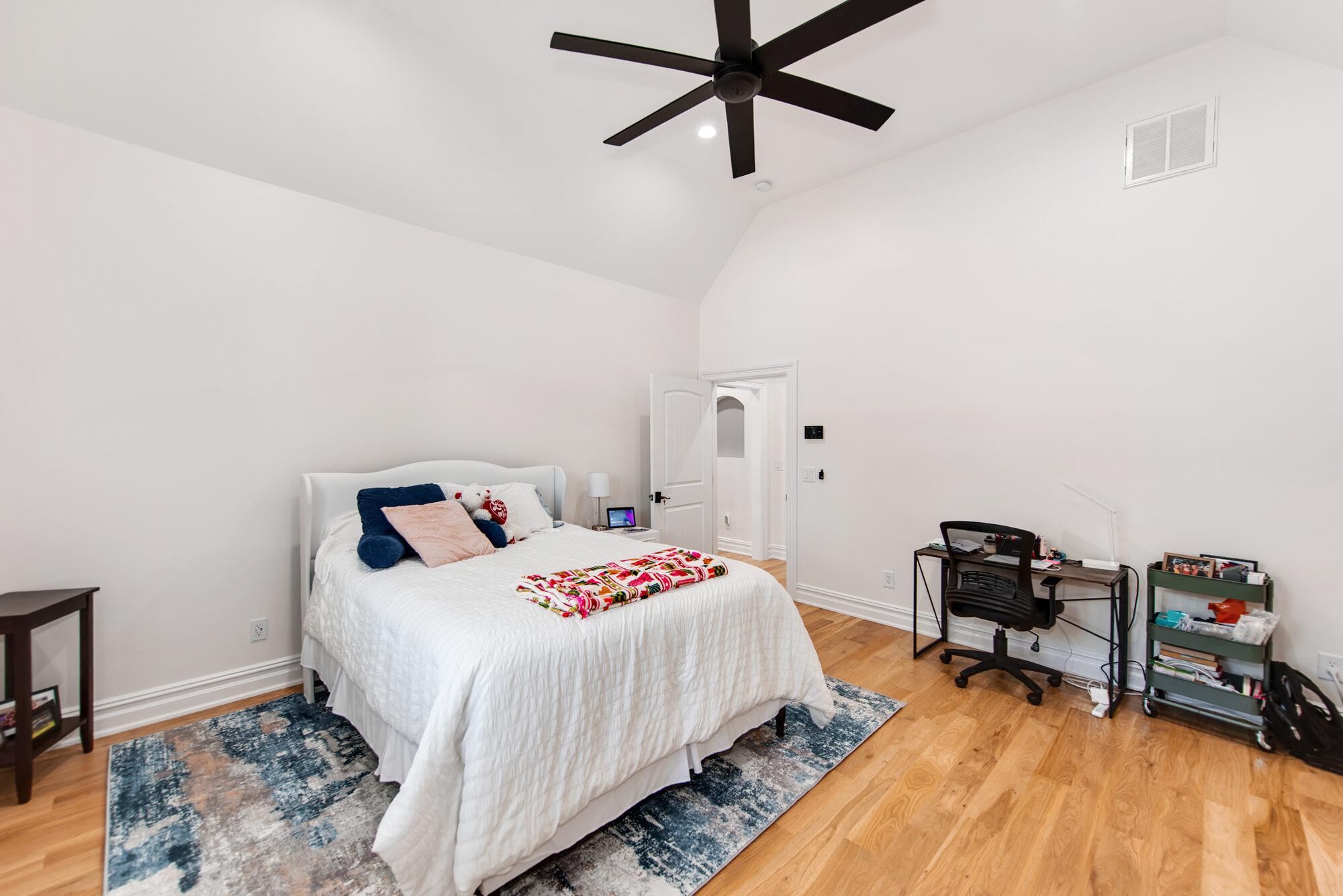 Guest suite with vaulted ceiling, sloped walls, and desk nook — Coddle Creek by Stillman Properties Concord NC