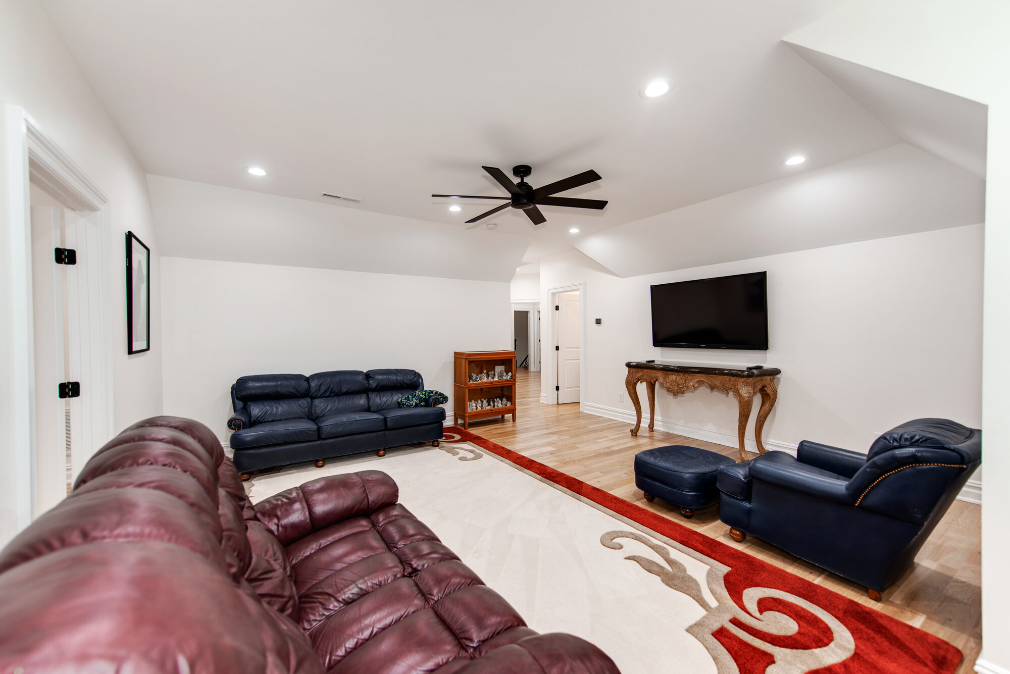 Bonus room alternate view with lounge seating and mounted television — Coddle Creek by Stillman Properties Concord NC