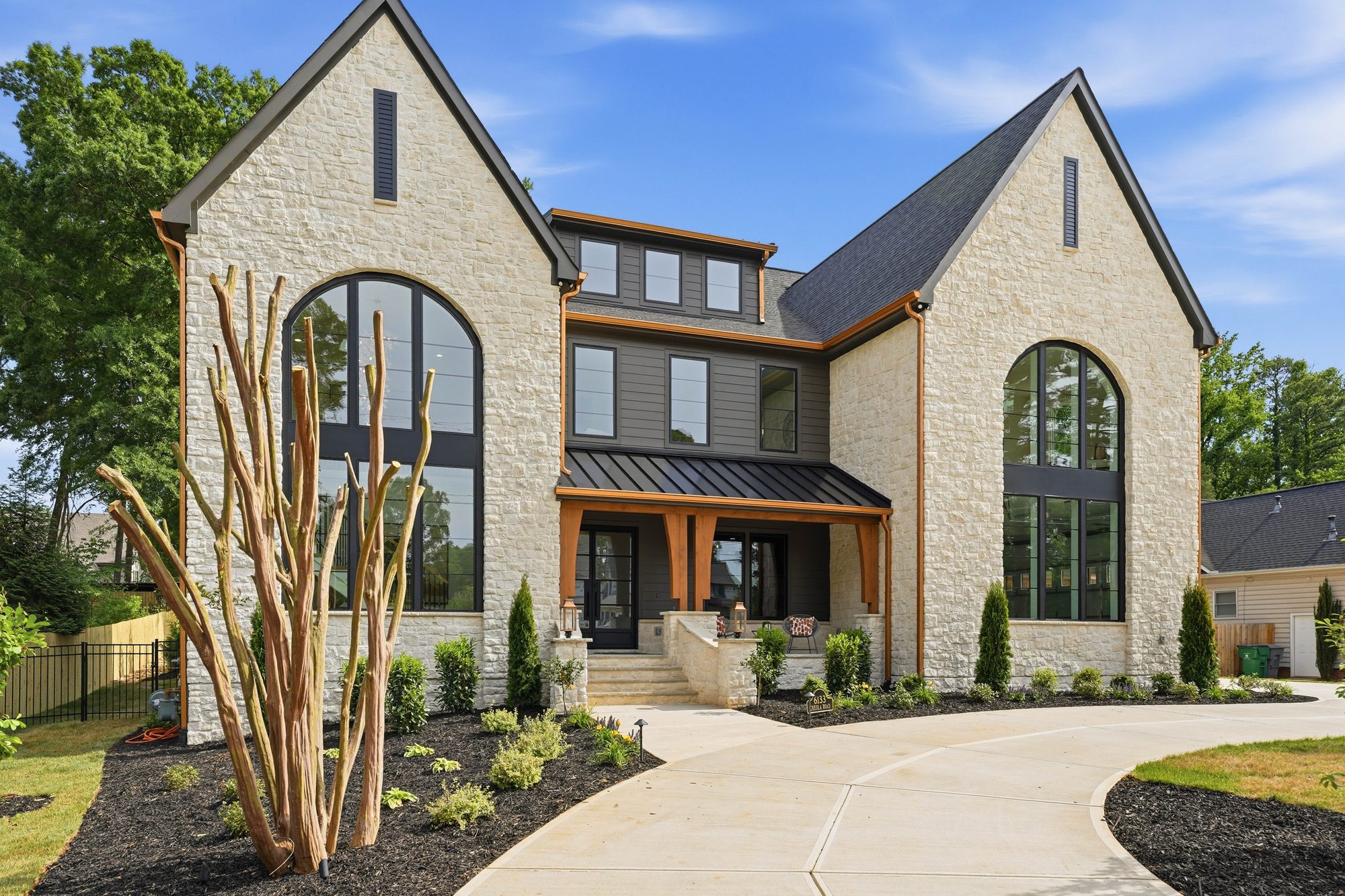 Creola custom home in Charlotte NC by Stillman Properties — front exterior with limestone gables and copper accents