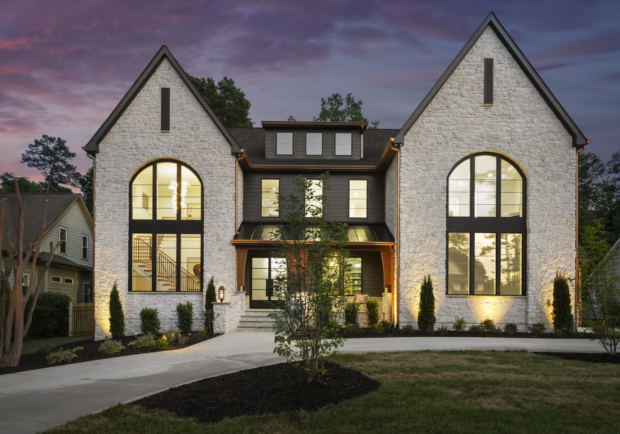 Front elevation of Creola at twilight with warm window glow — Creola custom home in Charlotte NC by Stillman Properties