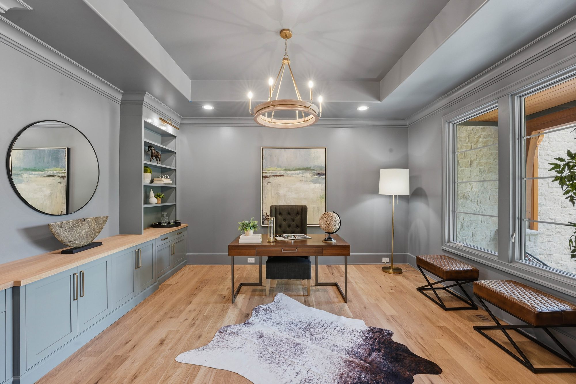Private office with tray ceiling, built-in shelving, and brass chandelier — Creola custom home in Charlotte NC by Stillman Properties