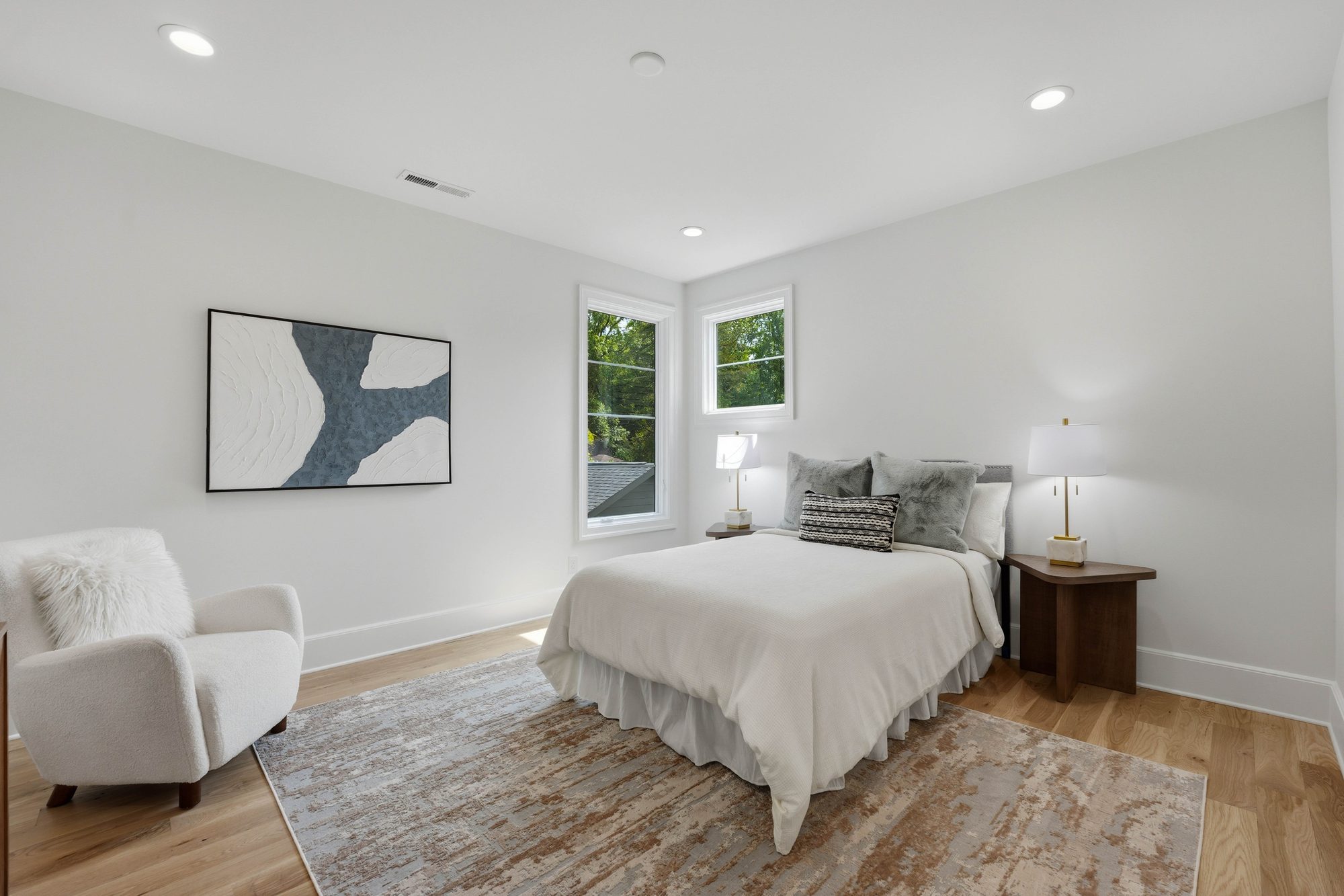 Serene guest bedroom with bouclé reading chair and refined neutral palette — Creola custom home in Charlotte NC by Stillman Properties