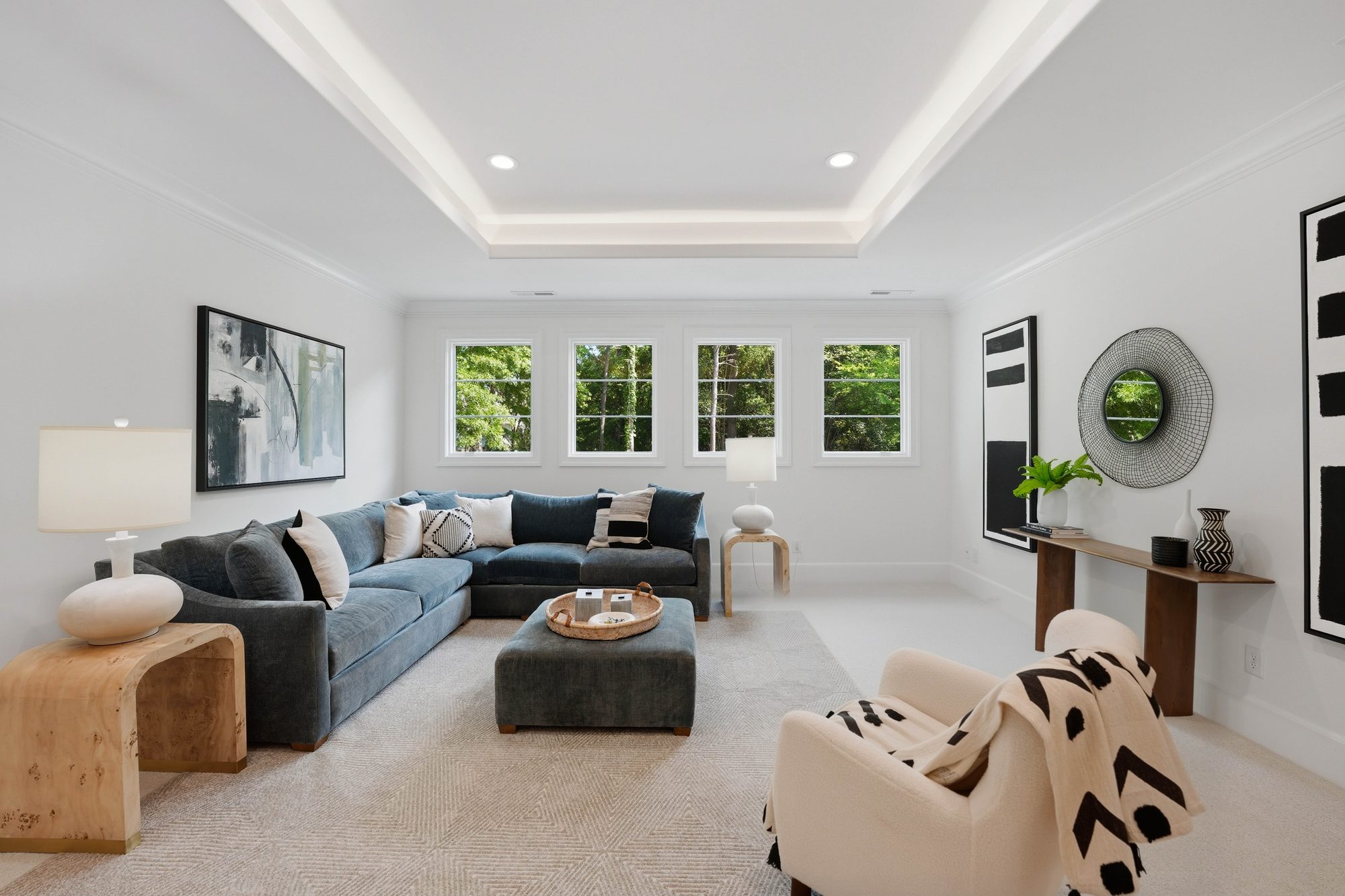 Bonus room sitting area with blue velvet sectional and gallery art — Creola custom home in Charlotte NC by Stillman Properties