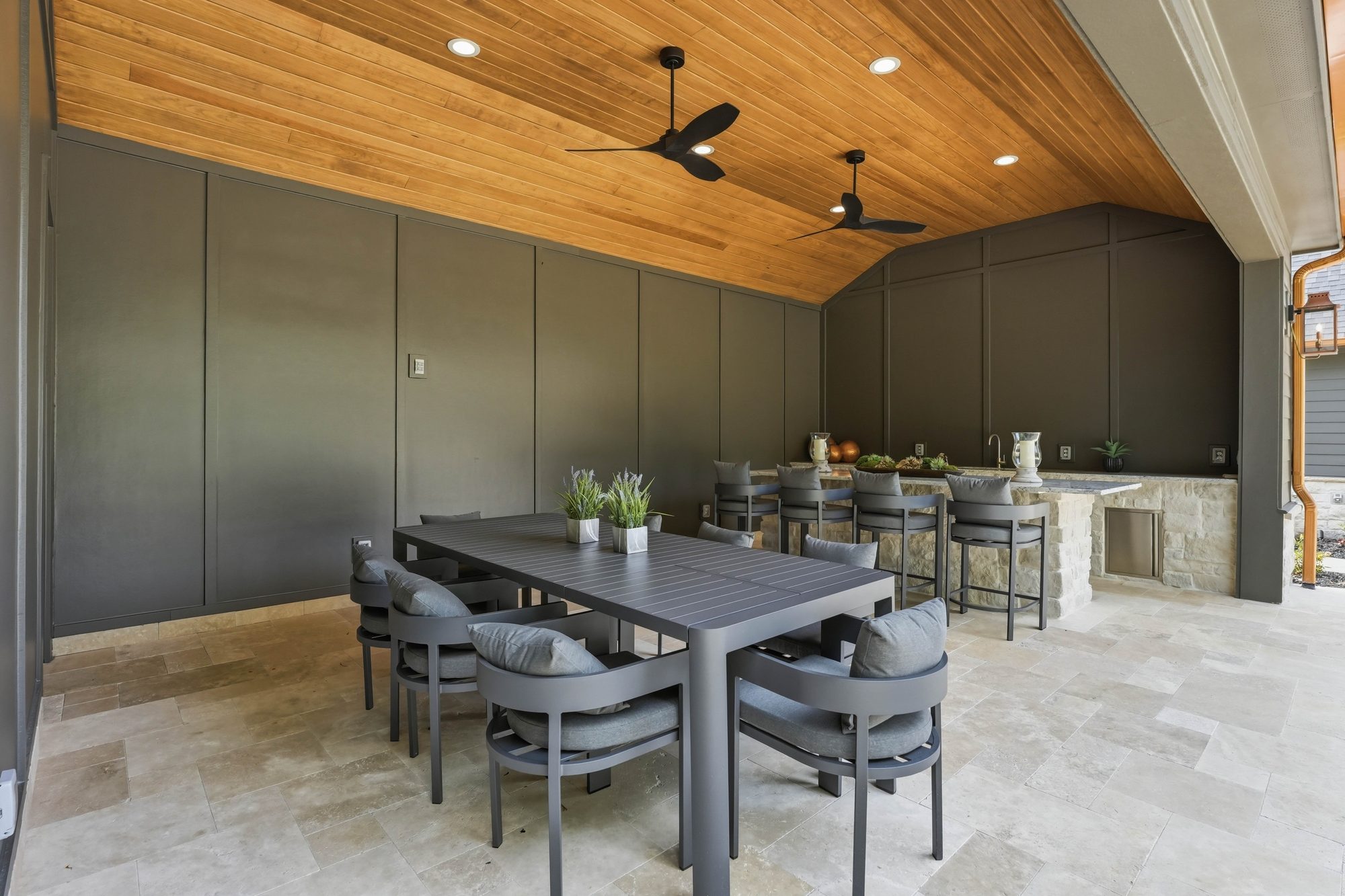 Pool cabana dining area with dark walls and wood-clad ceiling — Creola custom home in Charlotte NC by Stillman Properties