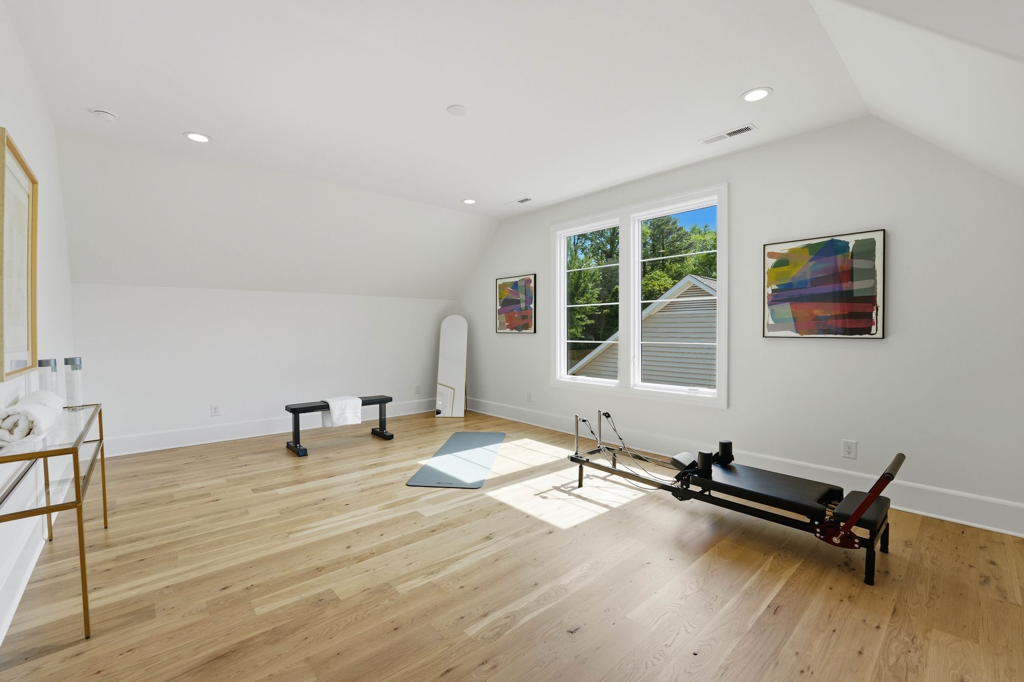 Upper-level flex room currently staged as a fitness studio with vaulted ceiling — Creola custom home in Charlotte NC by Stillman Properties