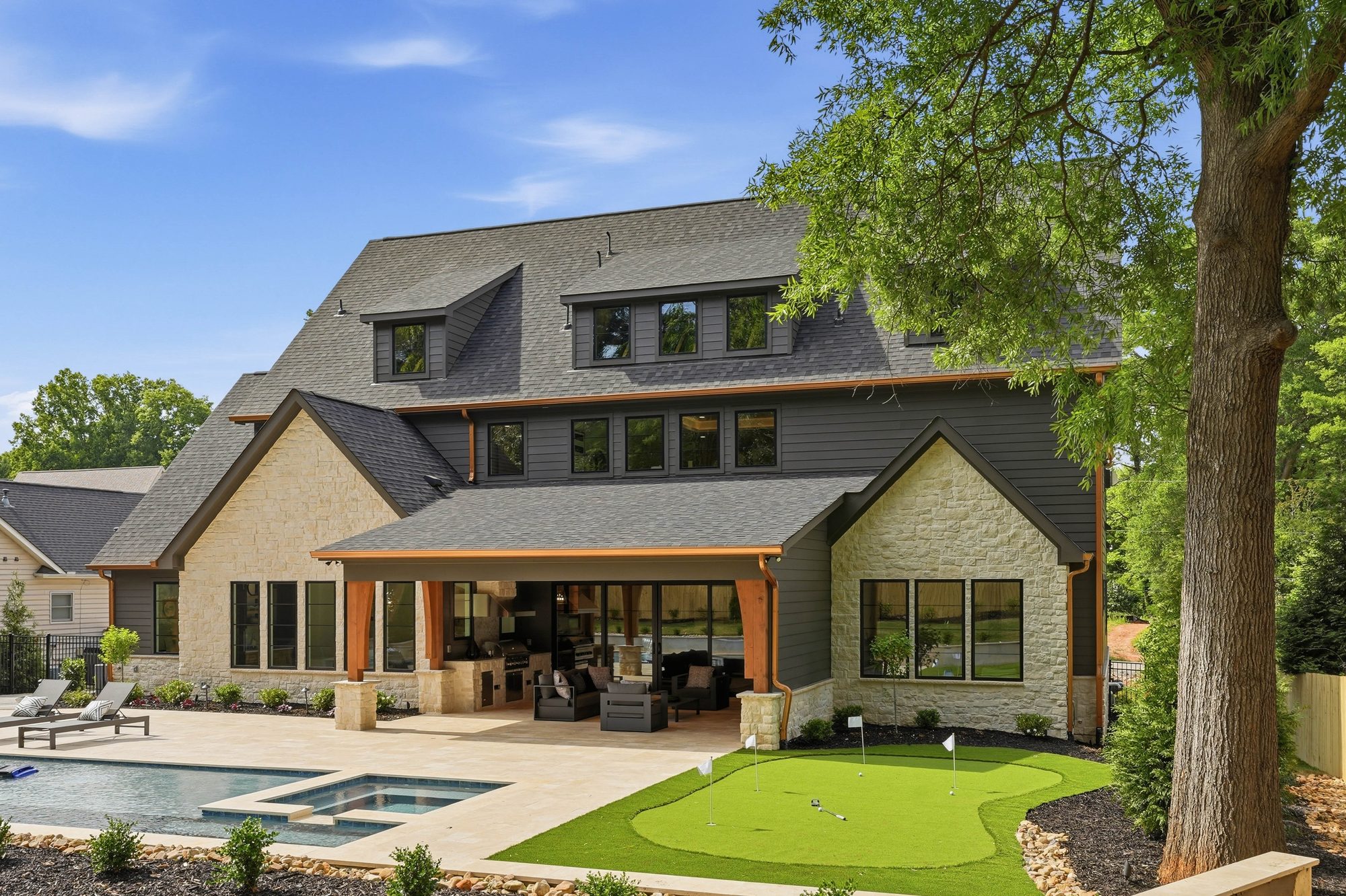 Rear three-quarter view of Creola showing the full outdoor living wing and roofline — Creola custom home in Charlotte NC by Stillman Properties