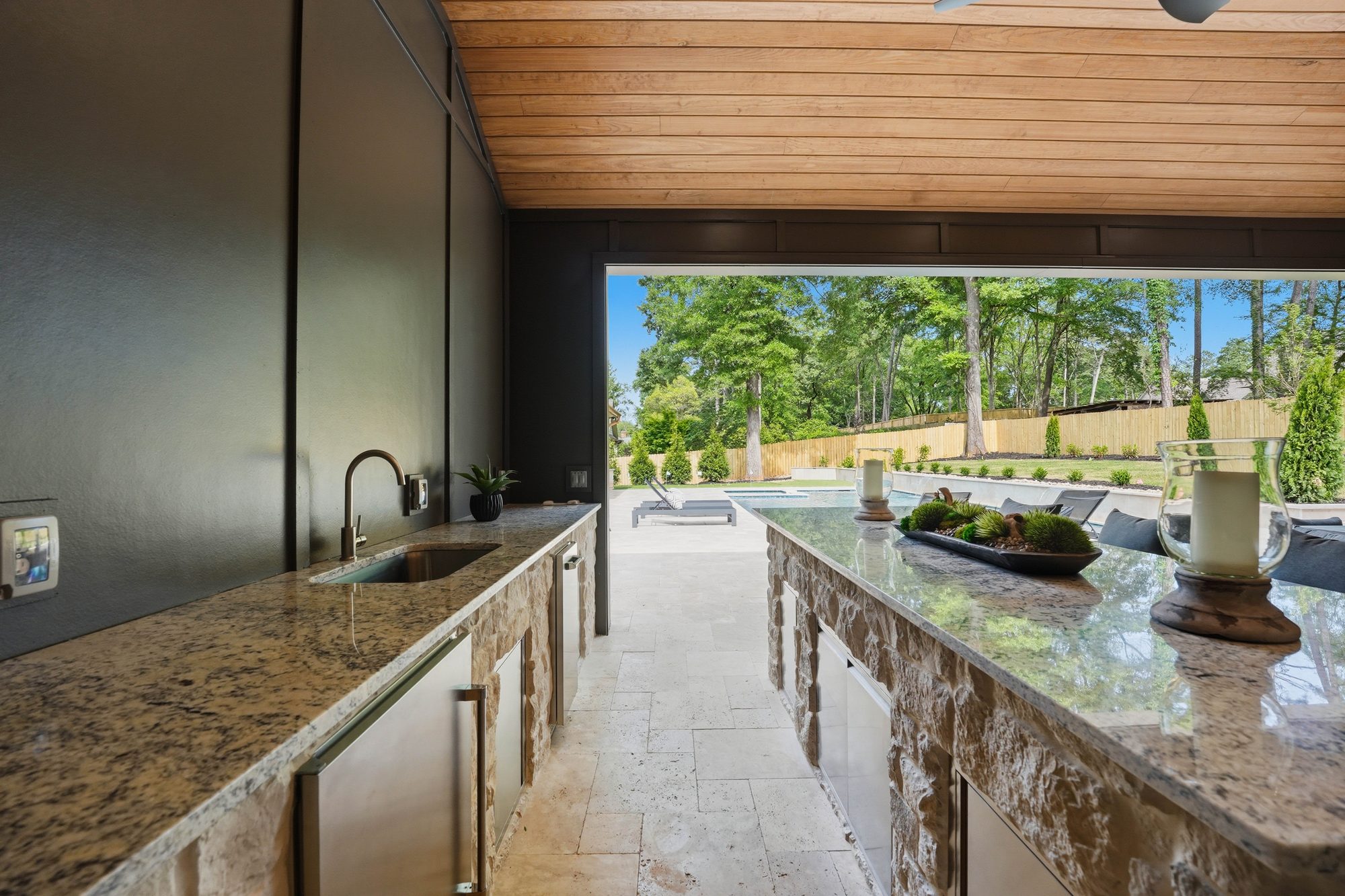 View through the cabana island looking out toward the pool deck — Creola custom home in Charlotte NC by Stillman Properties
