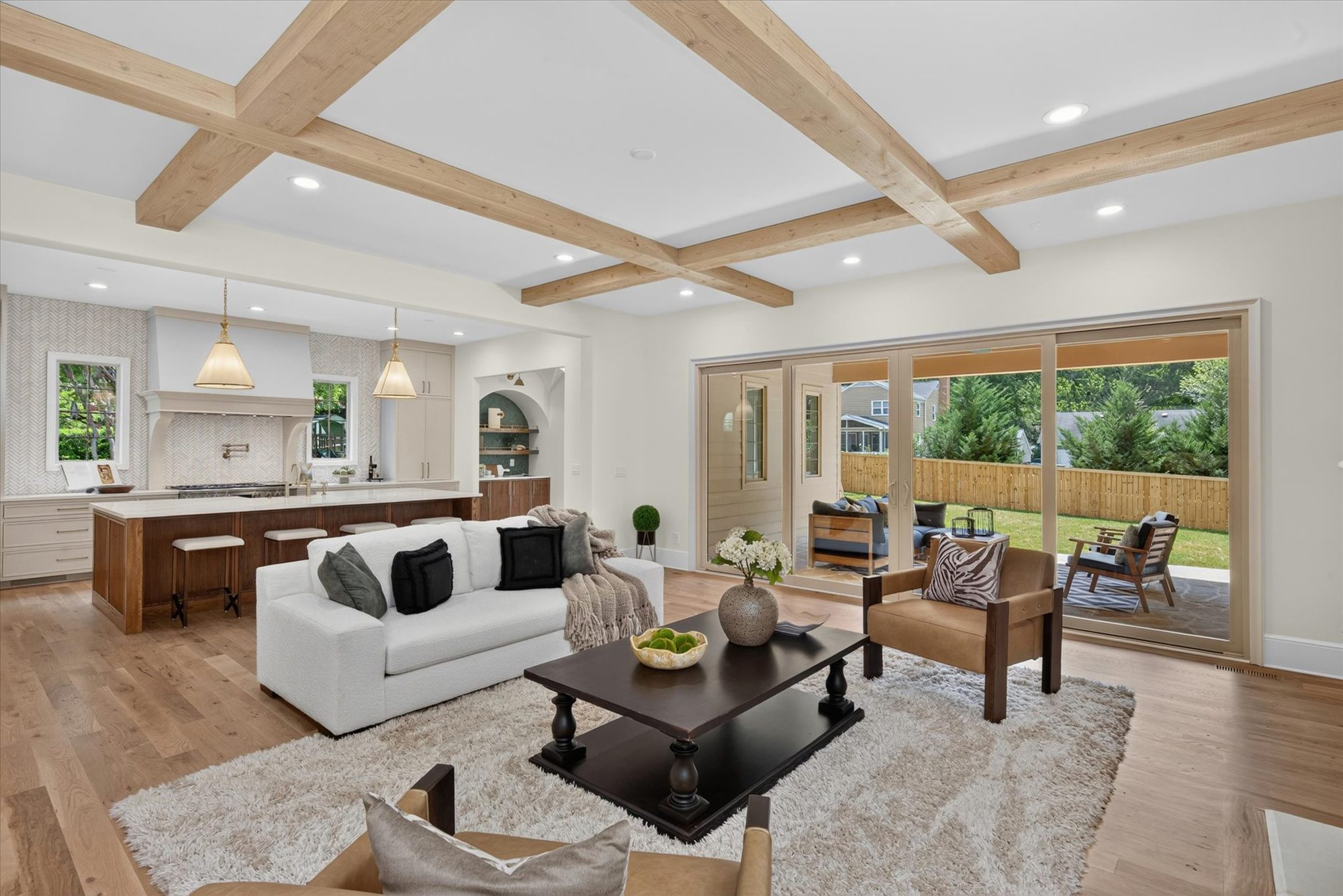 Great room looking toward the open kitchen island and porch sliders at Heather — Heather by Stillman Properties Charlotte NC