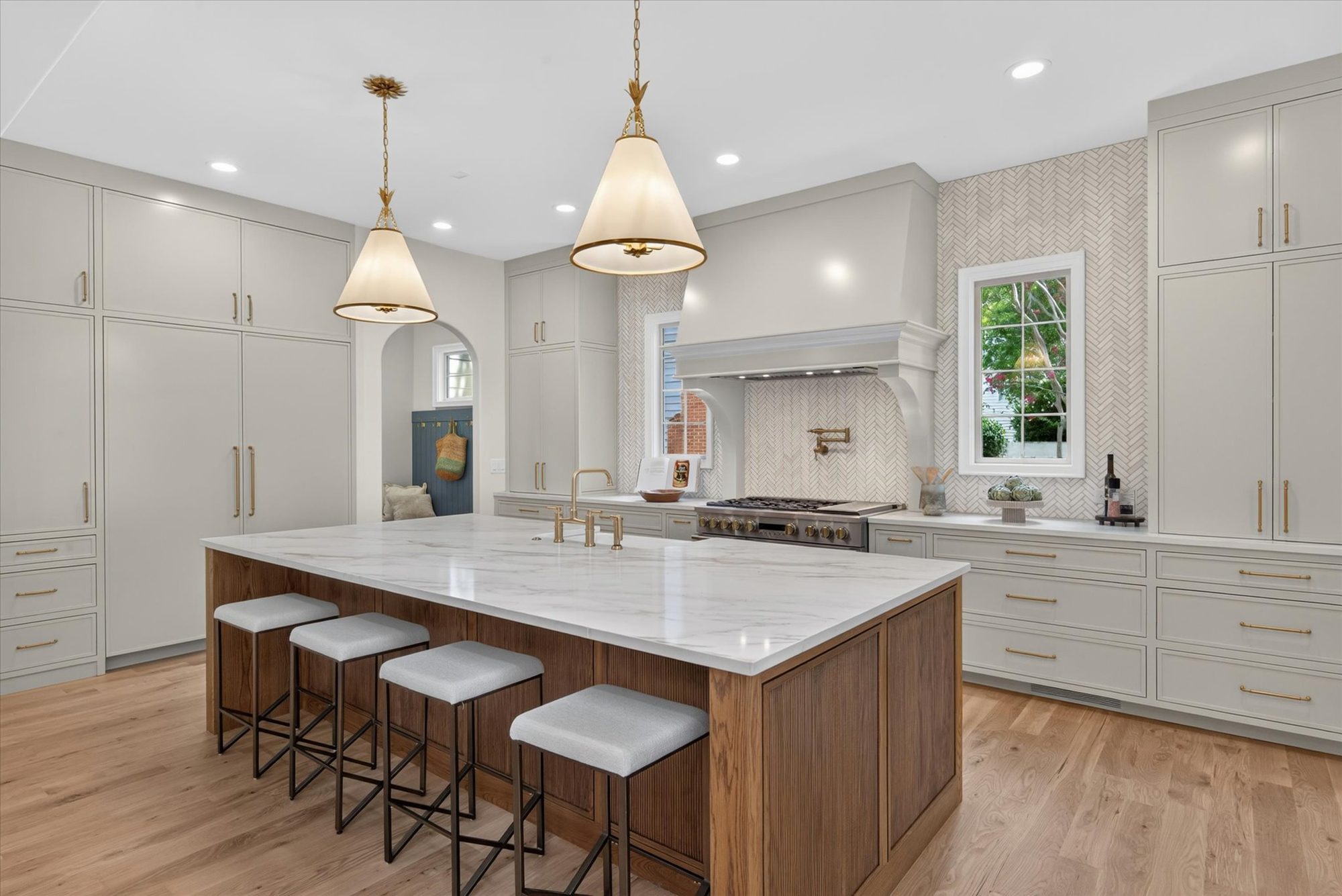 Alternate kitchen view at Heather showing island seating, professional range, and floor-to-ceiling paneled cabinetry — Heather by Stillman Properties Charlotte NC