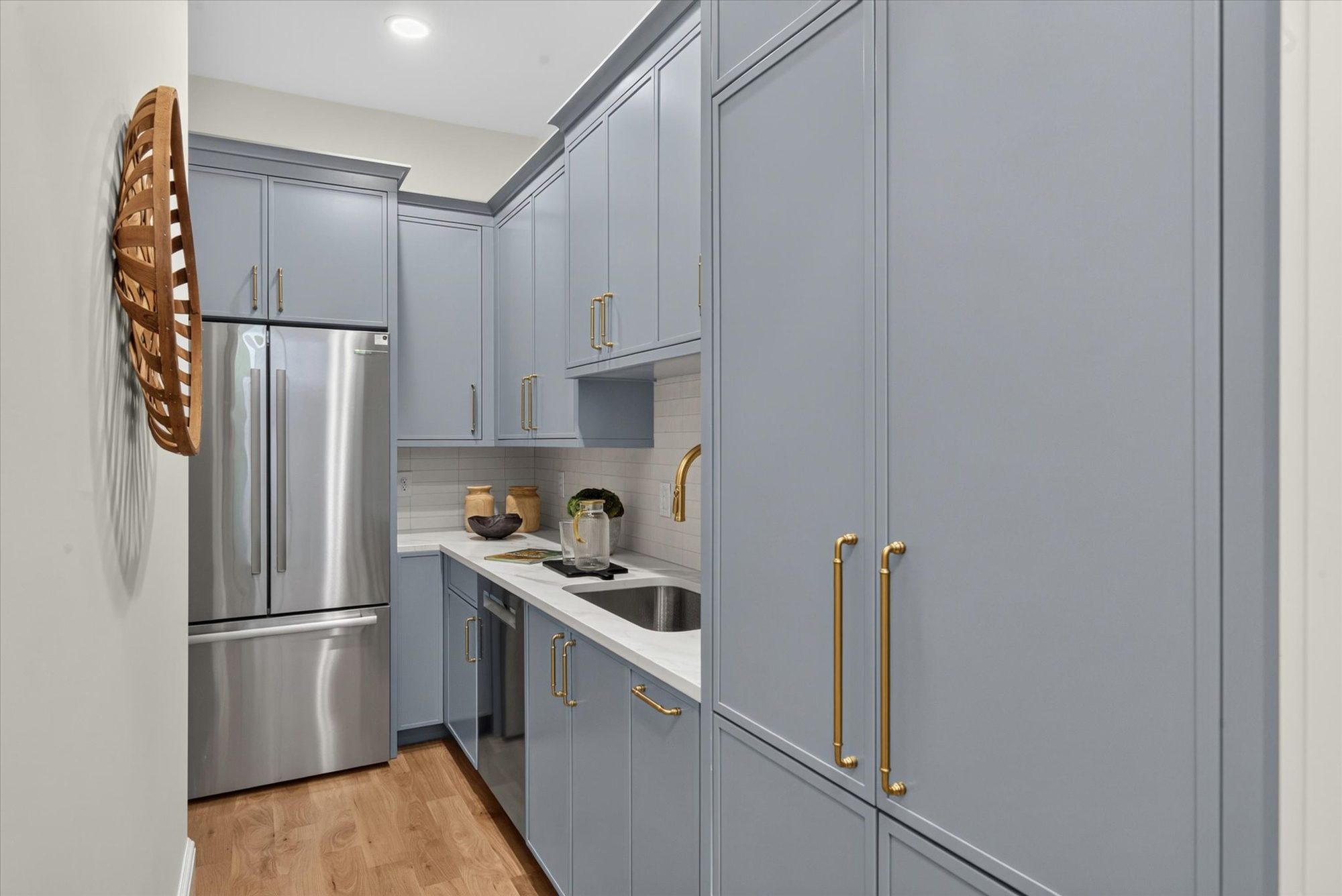 Scullery at Heather in blue-gray cabinetry with second refrigerator, prep sink, dishwasher, and brass hardware — Heather by Stillman Properties Charlotte NC