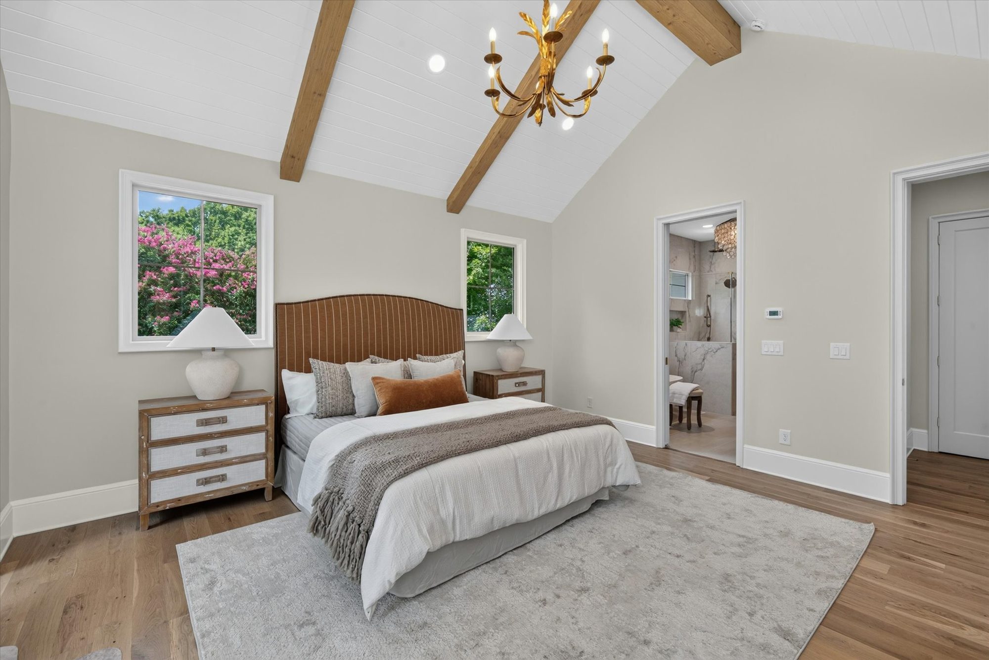 Primary bedroom at Heather looking toward the en-suite bath with marble shower beyond — Heather by Stillman Properties Charlotte NC