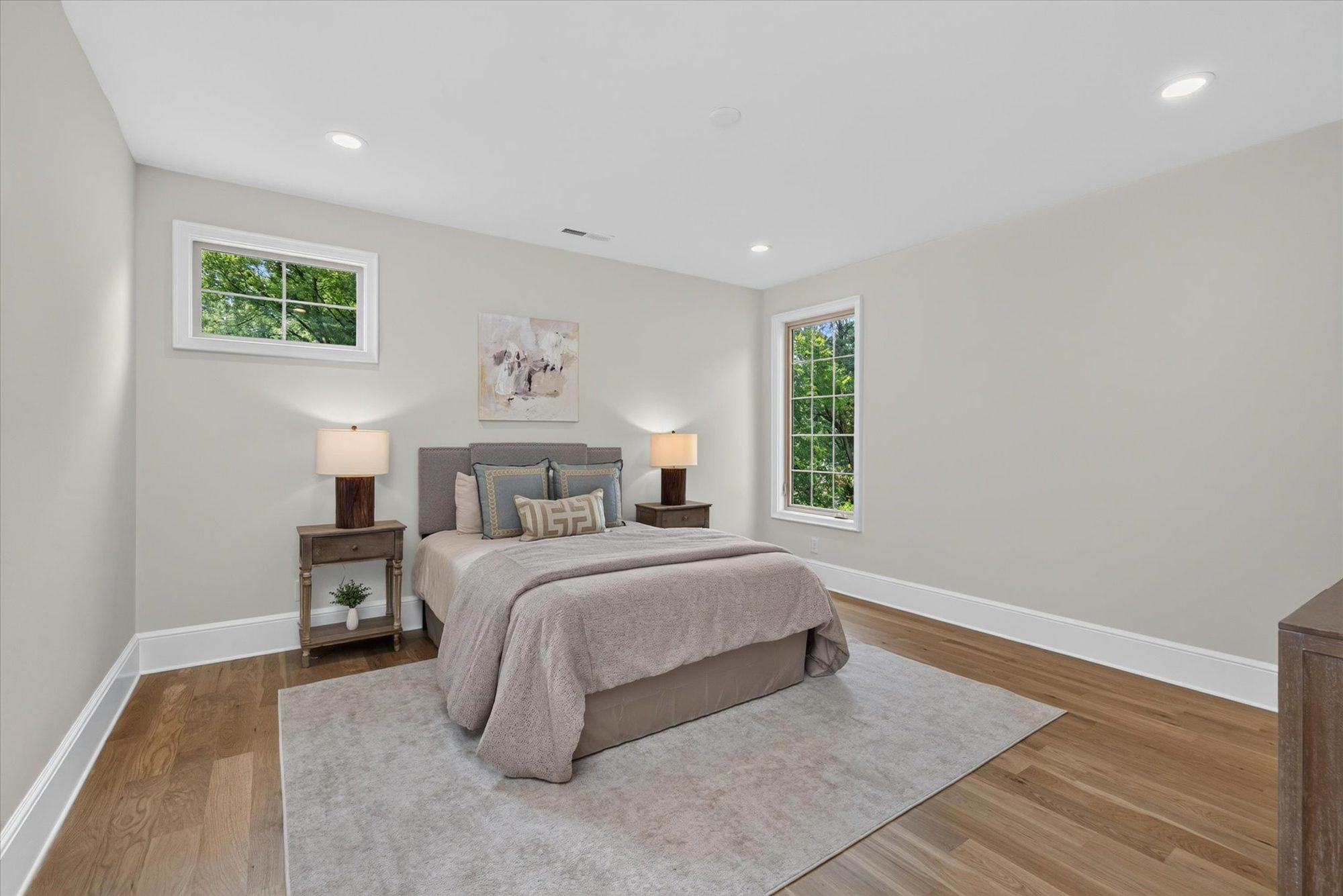 Bedroom at Heather with white oak floors, divided-light windows, and soft greige walls — Heather by Stillman Properties Charlotte NC