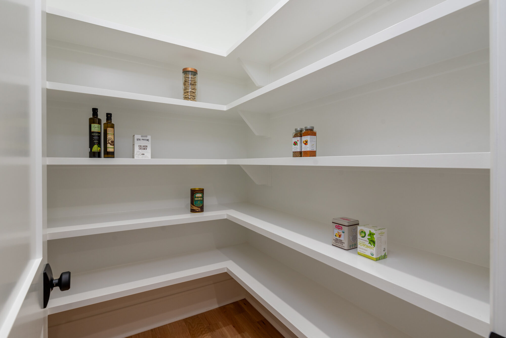 Walker walk-in pantry with white shelving and abundant storage — Stillman Properties Cotswold Charlotte NC