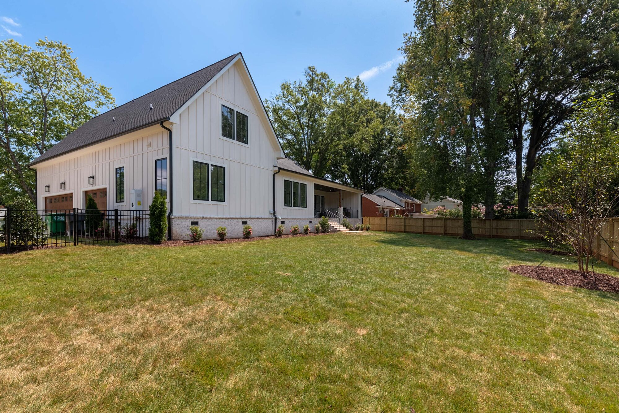 Walker side elevation with board-and-batten gable and detached two-car garage — Stillman Properties Cotswold Charlotte NC
