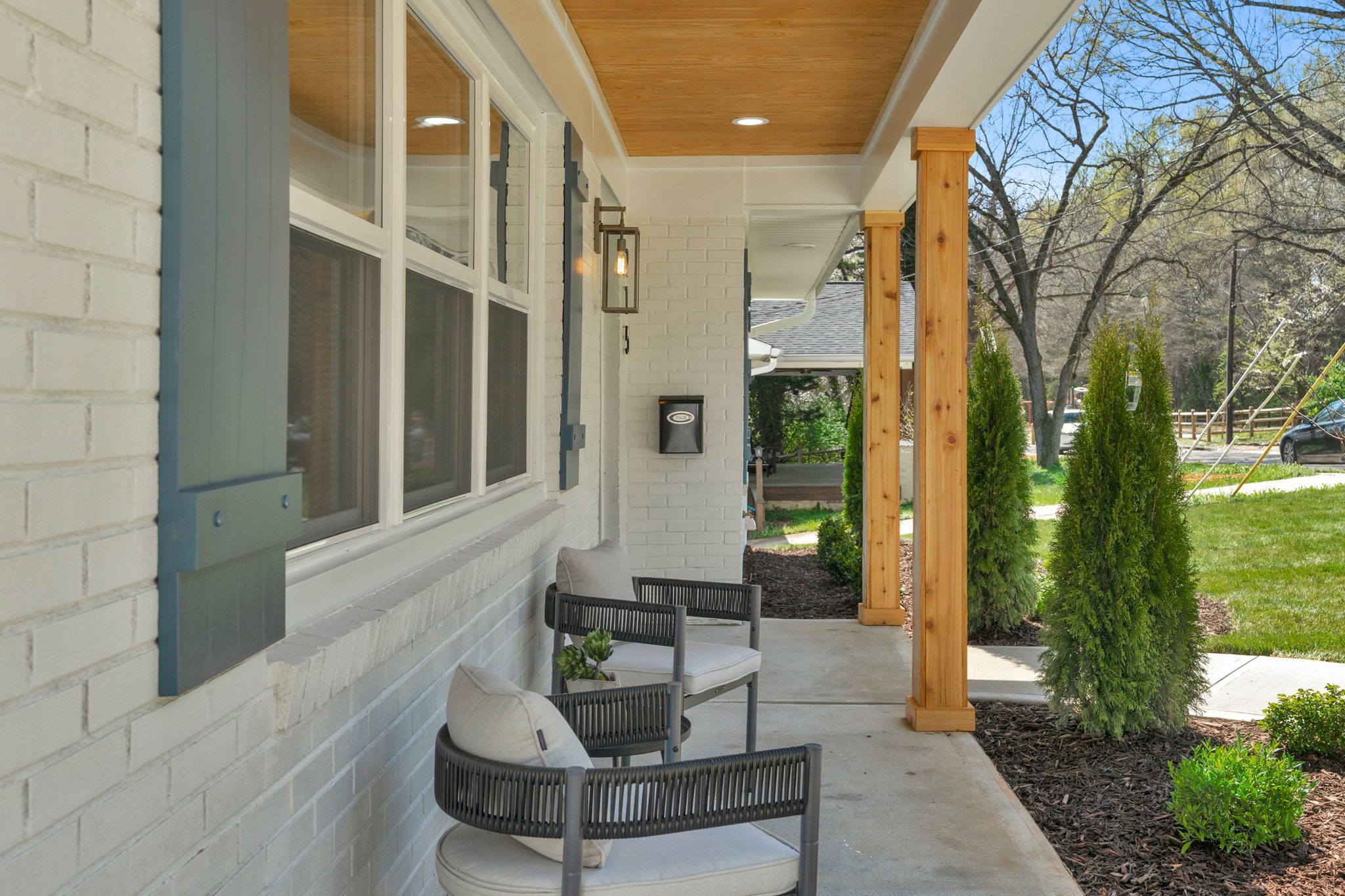 Covered front porch with cedar posts and seating — Wyanoke by Stillman Properties Charlotte NC