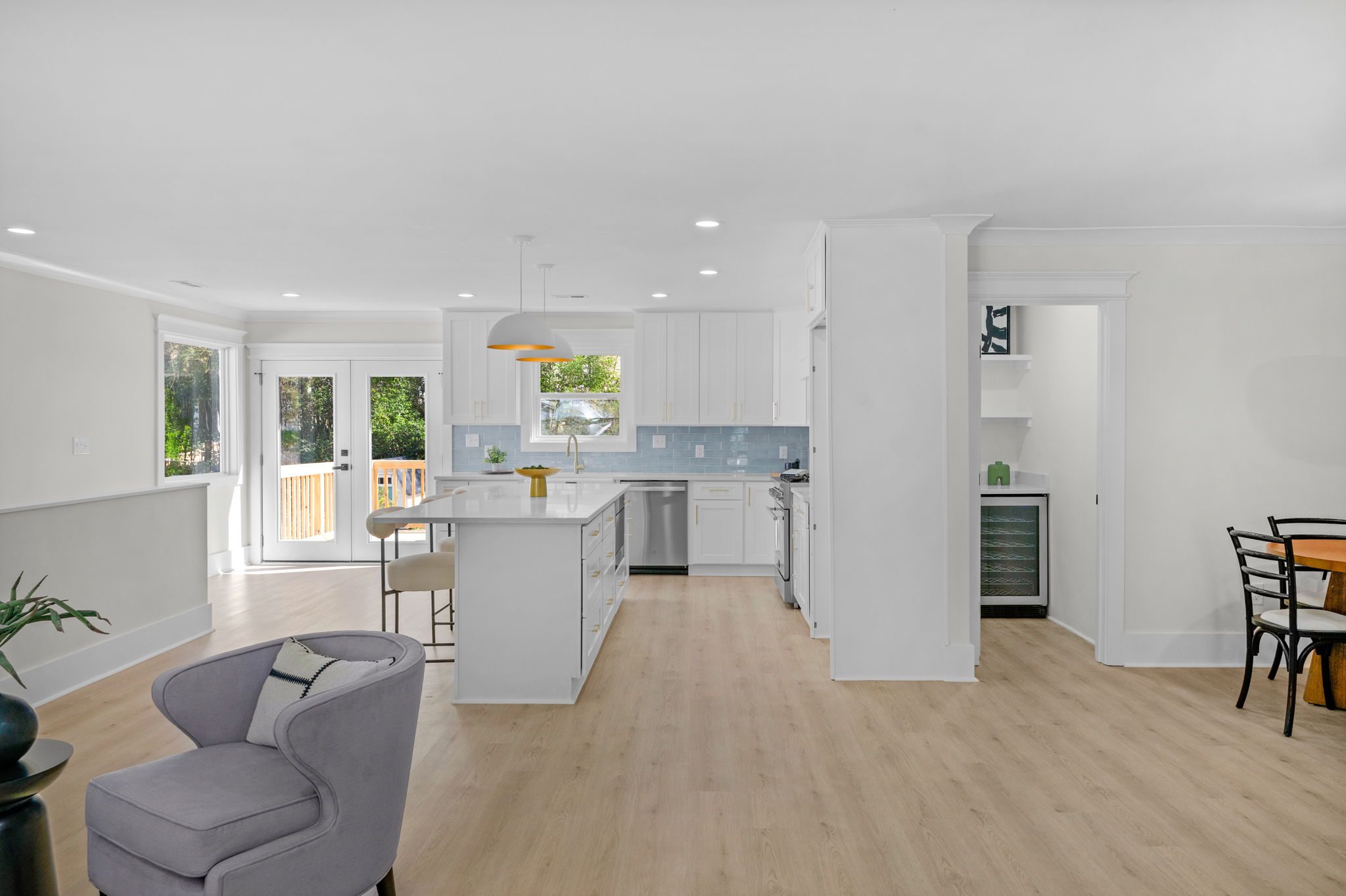 Open-concept living room flowing into the kitchen after the Wyanoke renovation — Stillman Properties Charlotte NC
