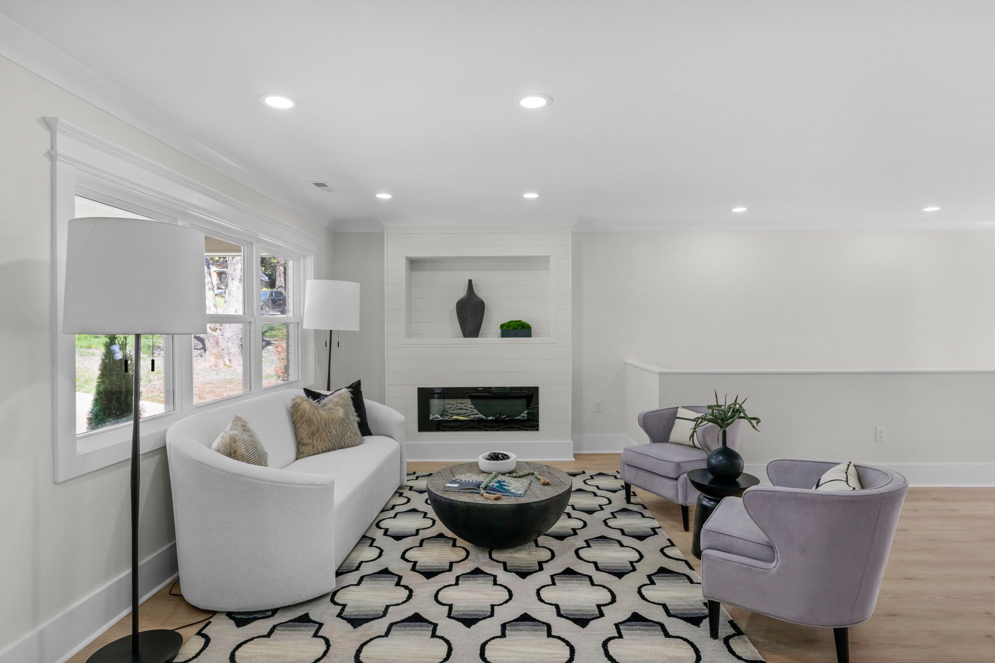 Living room sitting area with refinished light flooring and large windows — Wyanoke by Stillman Properties Charlotte NC