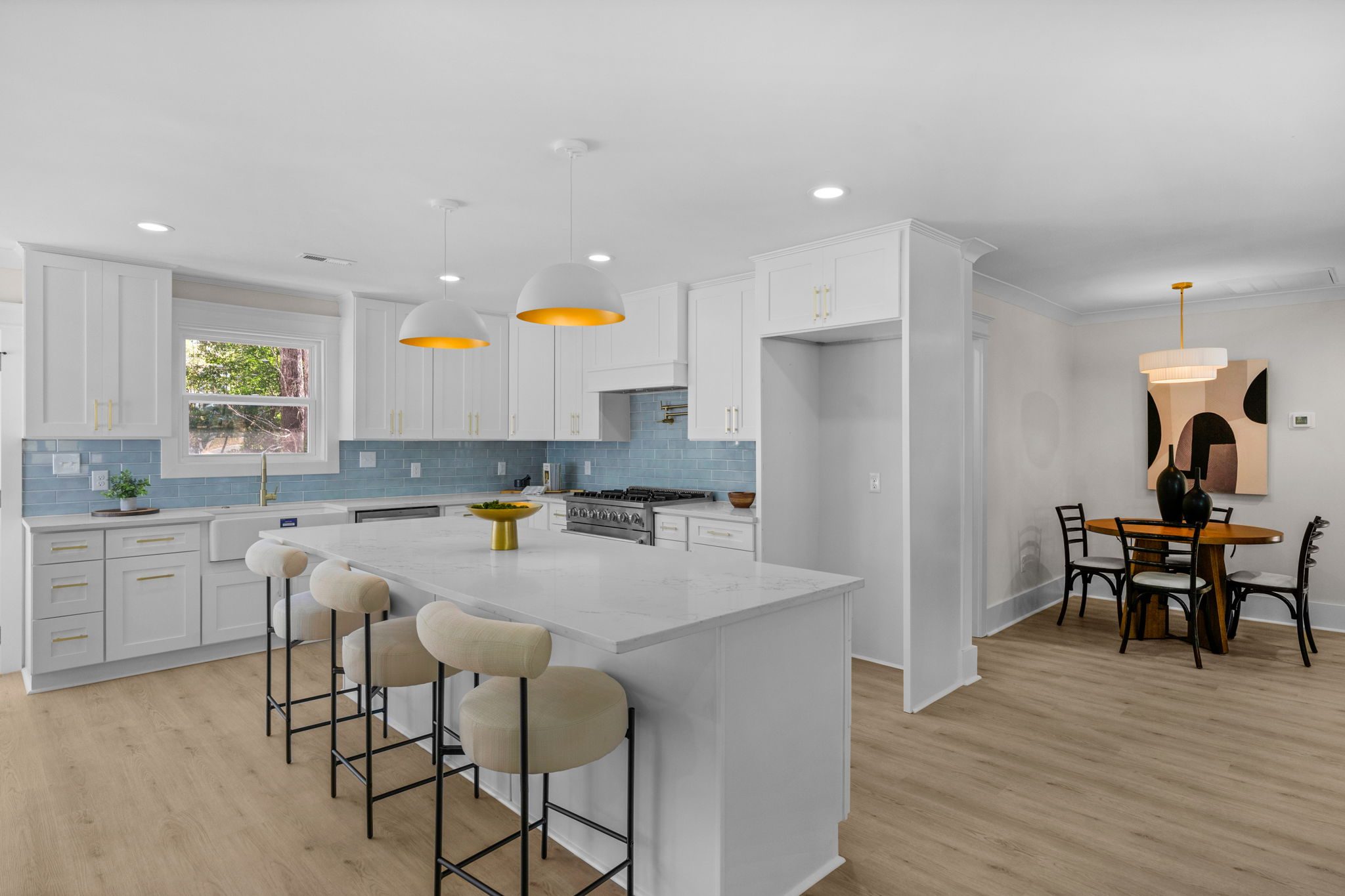 Wide view of the kitchen island open to the dining area — Wyanoke by Stillman Properties Charlotte NC