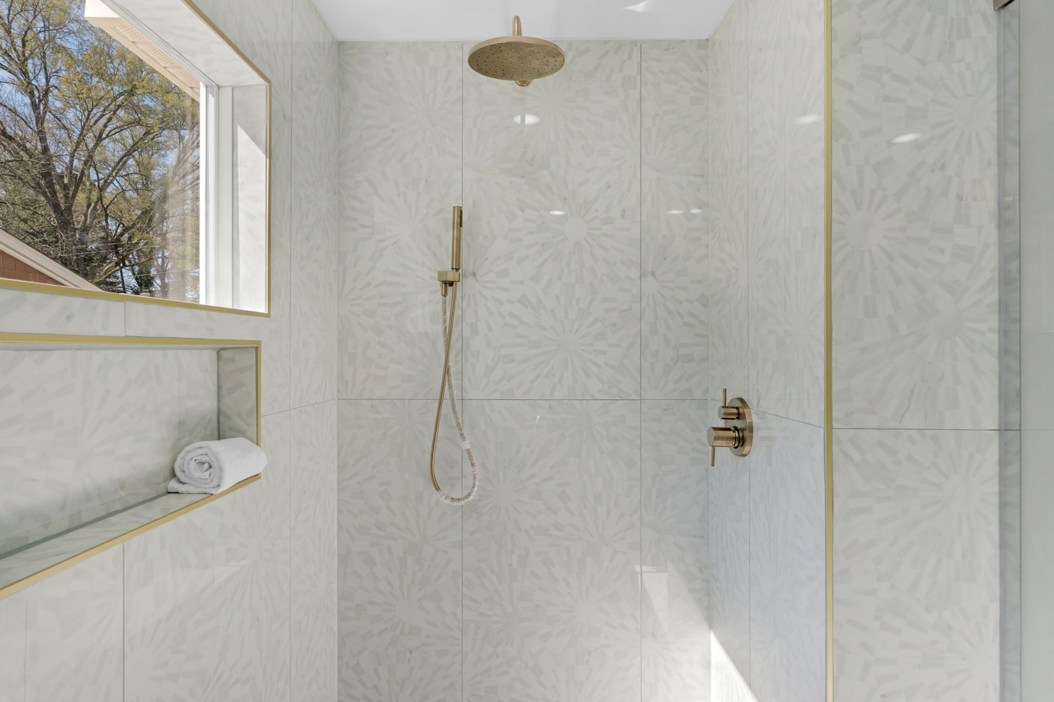 Primary bath walk-in shower with tile surround and gold fixtures — Wyanoke by Stillman Properties Charlotte NC