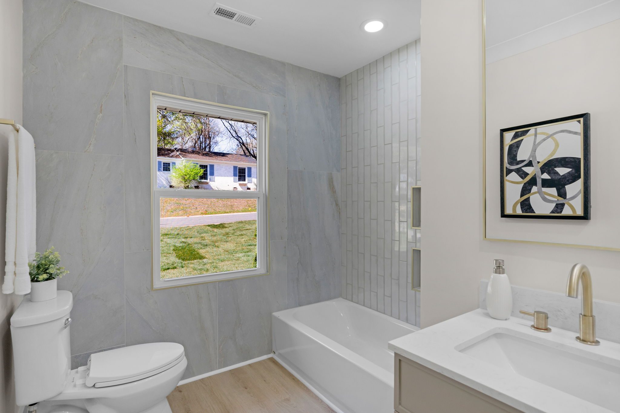 Renovated hall bath with tub-shower and tile surround — Wyanoke by Stillman Properties Charlotte NC