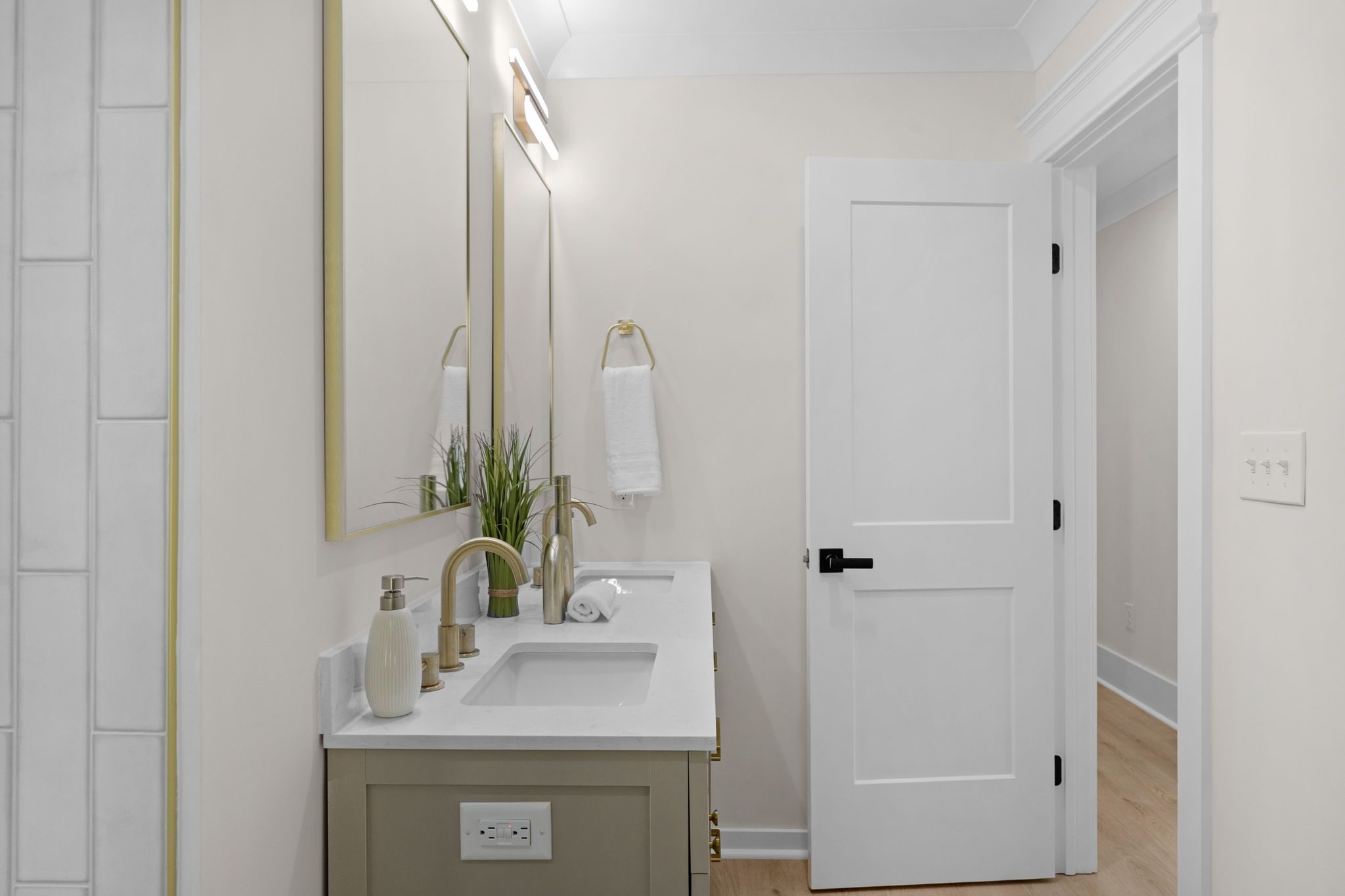 Hall bath vanity with framed mirror and modern fixtures — Wyanoke by Stillman Properties Charlotte NC