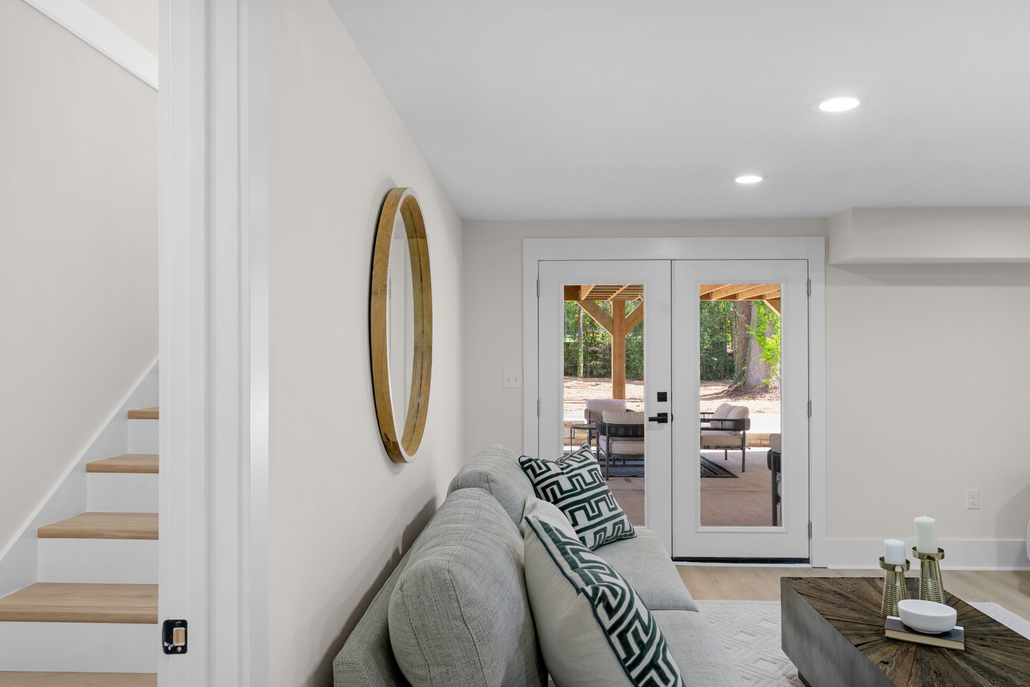 Lower-level family room with fireplace and walkout doors to the pavilion — Wyanoke by Stillman Properties Charlotte NC