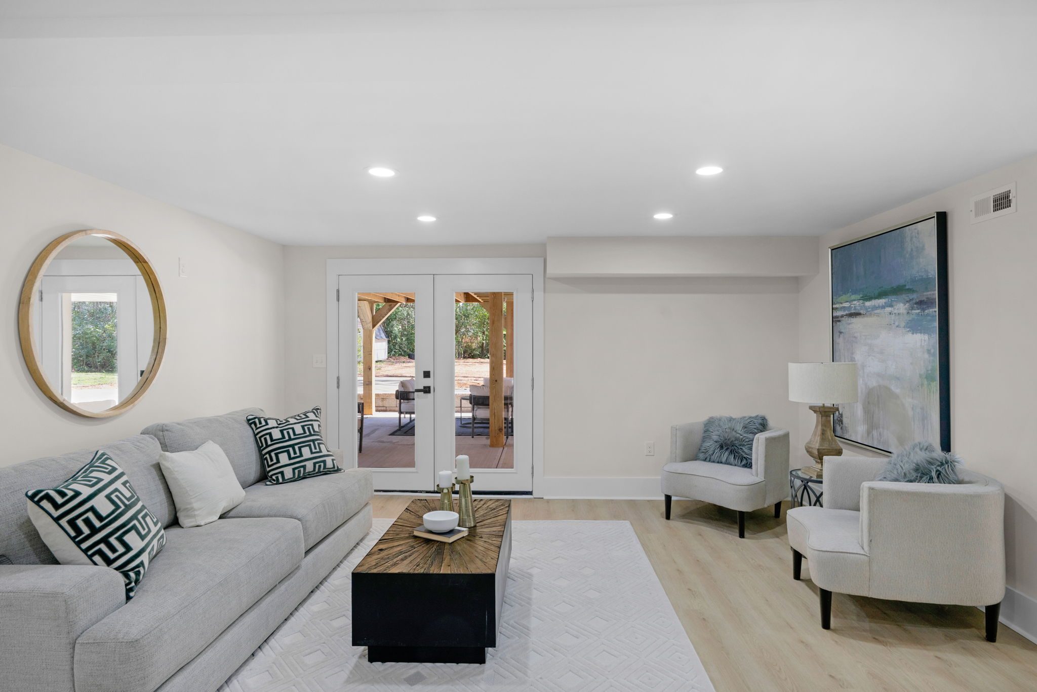 Lower-level living area with natural light from the walkout doors — Wyanoke by Stillman Properties Charlotte NC