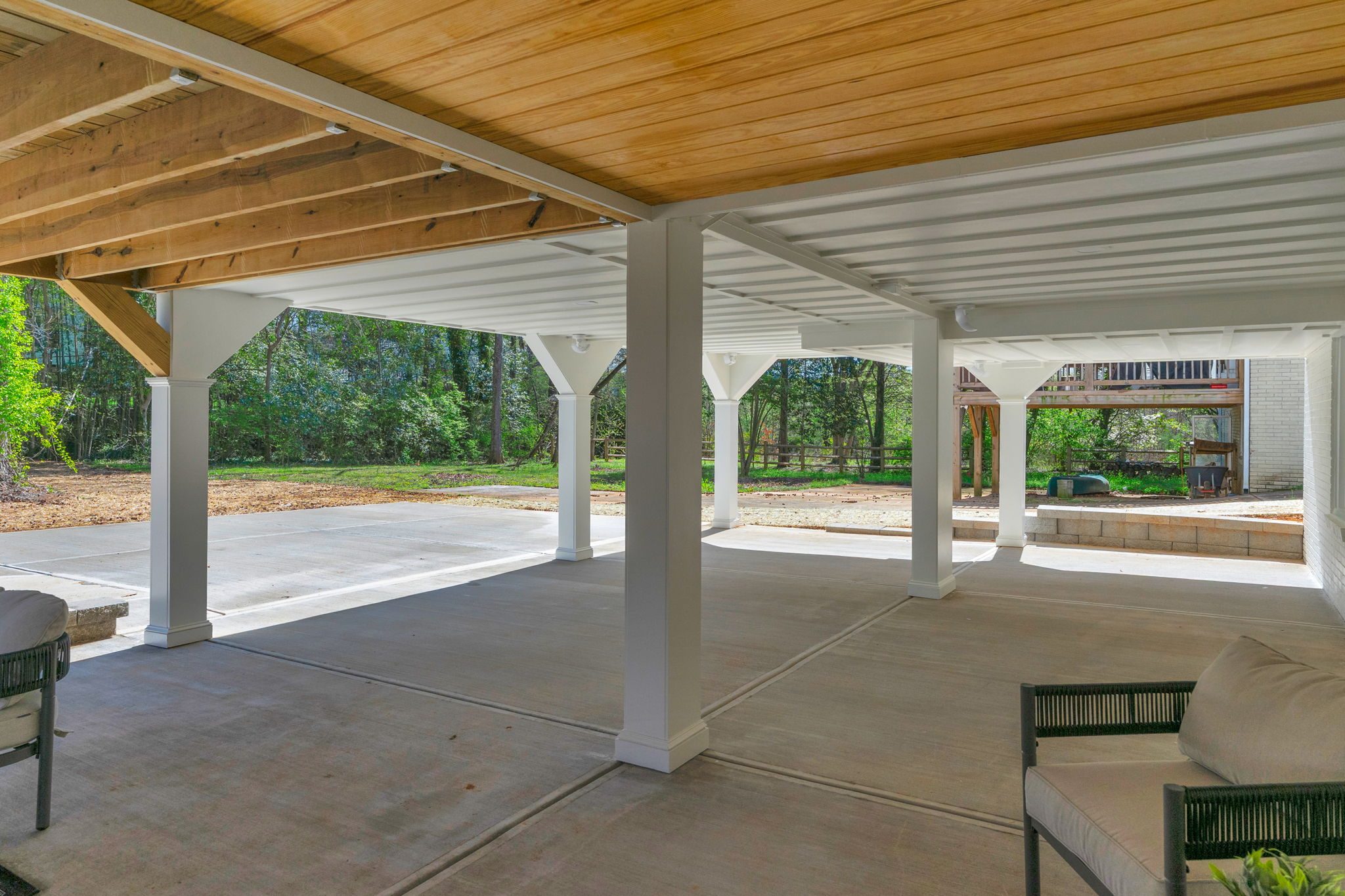 Covered pavilion seating area beside the finished concrete patio — Wyanoke by Stillman Properties Charlotte NC
